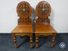 A pair of pitch pine hall chairs