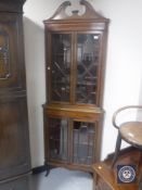 A Victorian inlaid mahogany corner cabinet with astral glazed doors