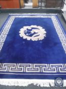 A blue fringed Chinese carpet