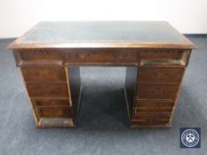 A Victorian mahogany twin pedestal writing desk fitted eleven drawers and tooled leather panel top