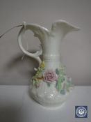 A Beleek floral encrusted jug, height 18.