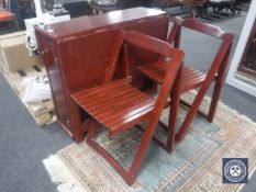 A drop leaf storage kitchen table and four chairs