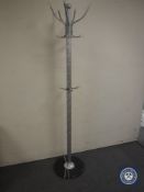 A hat and coat stand on a marble base