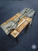 A three-piece antique brass companion set together with a music table and a two-tier brass pan