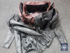 A holdall containing three leather coats