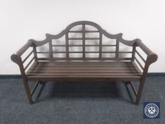 A teak scroll arm bench