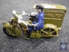 A cast metal figure of a postman on a motorbike with side car
