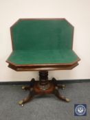 A Regency mahogany foldover top card table with baize-lined interior,