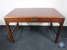 A writing table fitted a drawer in a mahogany finish