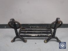 An antique cast iron fire grate