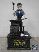 A cast metal John Deere money bank