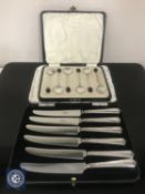 A cased set of six silver coffee spoons and a set of six silver-handled butter knives