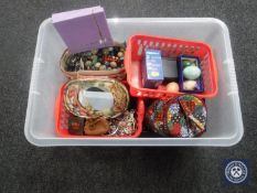 A plastic crate of costume jewellery, alabaster eggs, Remington travel clock,