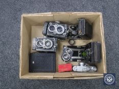 A box of two Rolleiflex folding cameras, Leica meter,