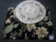 A contemporary black floral rug, 210cm by 160cm,