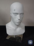 A gent's shop mannequin on metal stand