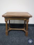 An antique oak pegged stool with under stretcher