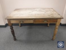 A pine farmhouse kitchen table fitted with two drawers