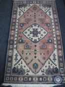 A fringed Persian style runner and a fringed rug on blue ground