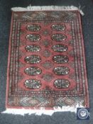 A Bokhara rug on pink ground