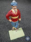 A cast metal figure of a golfer and a figure of a boxer