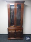 A mahogany glazed door bookcase fitted cupboards and drawers beneath