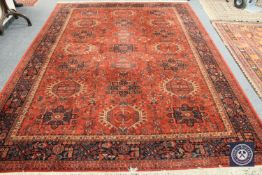 A machine made carpet of Persian design,