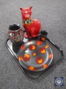 Four pieces of Poole pottery including cat,