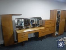 A four-piece mid 20th century teak Uniflex bedroom suite and a headboard
