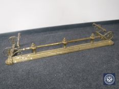 A Victorian brass fire curb