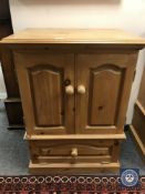 A pine double door cabinet,