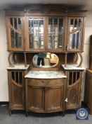 A late Victorian oak mirror-backed marble top sideboard,