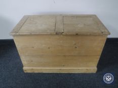 An antique stripped pine storage box