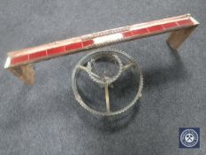 An antique brass circular light fitting and a copper tiled fire curb