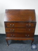 A mahogany bureau on cabriole legs