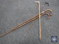 Four antique walking sticks with silver mounts