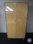 A mid 20th century teak double door wardrobe