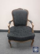 A salon armchair in black floral fabric