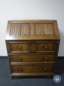 An oak linen fold bureau