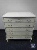 A cream and gilt five drawer chest