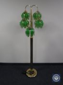A contemporary brass five-way floor lamp with glass shades