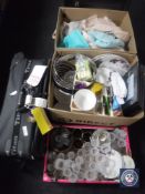 Two luggage cases together with three boxes containing towels, glass ware, dinner ware,