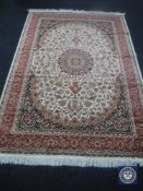 A Keshan carpet, on beige ground,