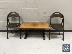 An oak refectory coffee table together with a pair of folding chairs