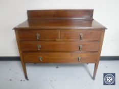 A Victorian inlaid mahogany four drawer chest