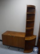 A set of teak open corner shelves together with a teak double door cabinet on metal legs