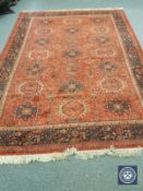 A machine made carpet of Persian design,