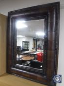 A leather framed bevelled edge mirror