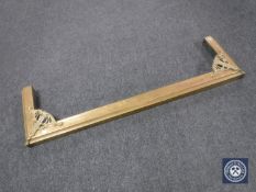 An early 20th century brass fender