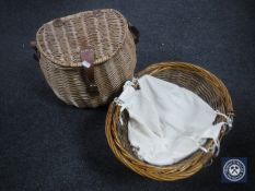 A wicker fishing creel together with an antique wicker hand basket